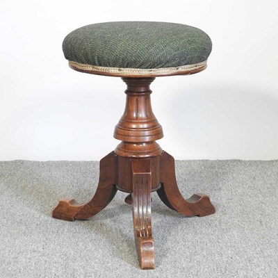 Lot 135 - A Victorian walnut revolving piano stool,...