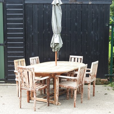 Lot 18 - A teak garden table, together with a set of...