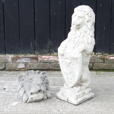 Lot 505 - A cast stone model of a lion with shield, 82cm...