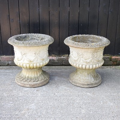 Lot 140 - A pair of cast stone campana shaped garden...