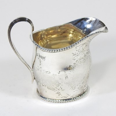 Lot 138 - An Edwardian silver cream jug, with a...