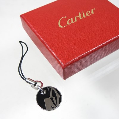 Lot 57 - A Cartier black enamelled luggage tag, 20mm...