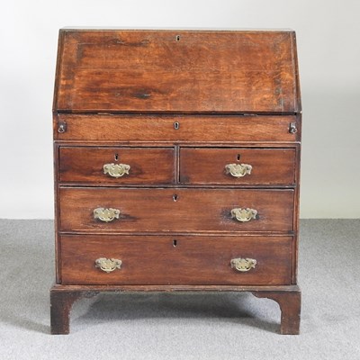 Lot 587 - An 18th century oak bureau, fitted with a well,...