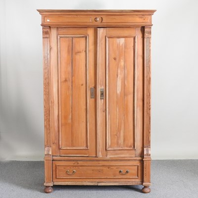 Lot 320 - An early 20th century continental pine armoire,...