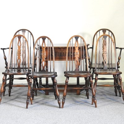 Lot 137 - An oak side table, together with six wheelback...