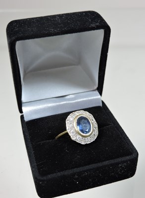 Lot 31 - An 18 carat gold sapphire and diamond cluster ring