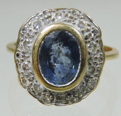 Lot 31 - An 18 carat gold sapphire and diamond cluster ring