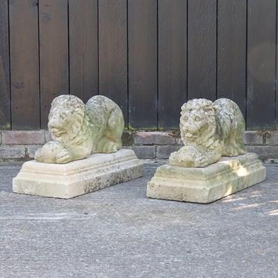 Lot 300 - A pair of reconstituted stone garden models of lions