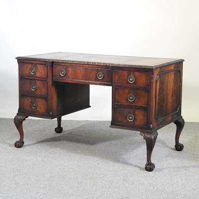 Lot 120 - An early 20th century kneehole desk, with an...