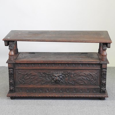 Lot 340 - A 19th century carved oak monk's bench, with...