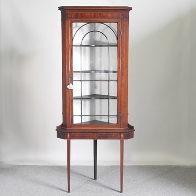 Lot 527 - A 19th century glazed corner cabinet, on a...