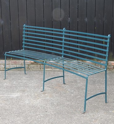 Lot 303 - A green painted wrought iron garden bench