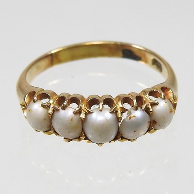 Lot 238 - An 18 carat gold dress ring set with a row of...