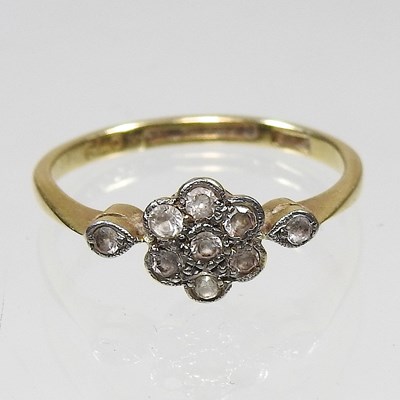 Lot 295 - An 18 carat gold and diamond daisy set cluster...