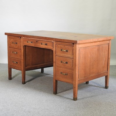 Lot 737 - A mid 20th century light oak pedestal desk