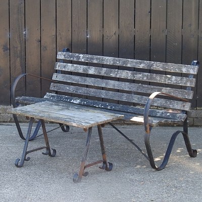 Lot 366 - A slatted wooden garden bench, on metal...