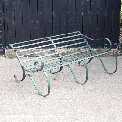 Lot 590 - A green painted iron garden bench, on scrolled...