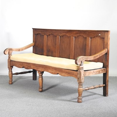 Lot 334 - An 18th century fruitwood settle, with a...