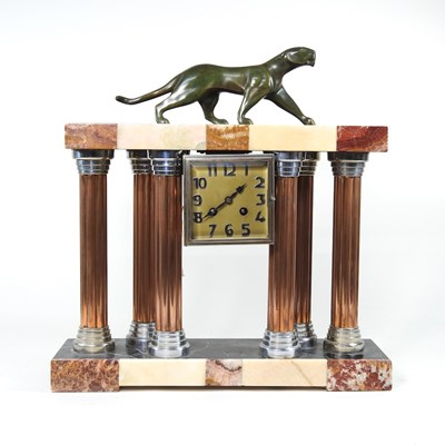 Lot 501 - An Art Deco marble mantel clock, surmounted by...