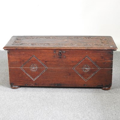 Lot 222 - An 18th century carved oak sword chest, with a...