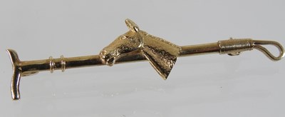 Lot 65 - A 9 carat gold sapphire and diamond set horseshoe bar brooch