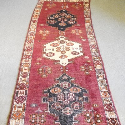 Lot 339 - A Persian runner, with three hooked medallions,...