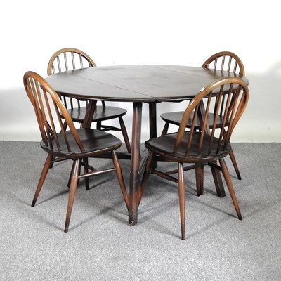 Lot 336 - A 1970's Ercol dark elm drop leaf dining table,...