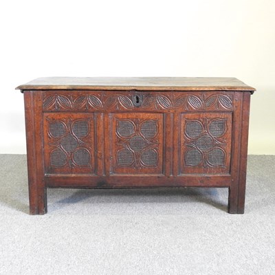 Lot 442 - An 18th century carved oak coffer, with a...