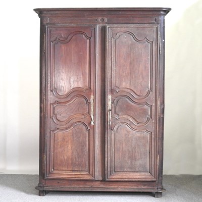 Lot 257 - A 19th century French oak armoire, enclosed by...