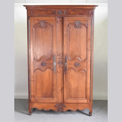 Lot 264 - A 19th century French fruitwood armoire, with...