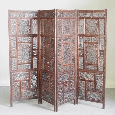 Lot 485 - An ornate Moroccan hardwood four fold screen,...