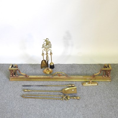 Lot 326 - A brass fender, together with a companion set...