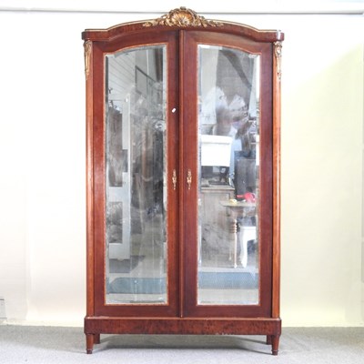 Lot 321 - An early 20th century French armoire, enclosed...