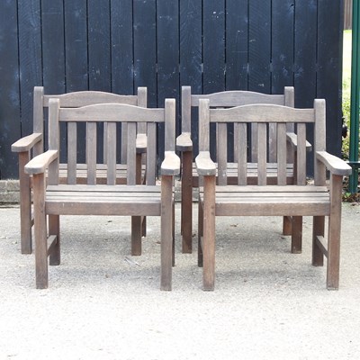 Lot 563 - A set of four teak garden armchairs (4)