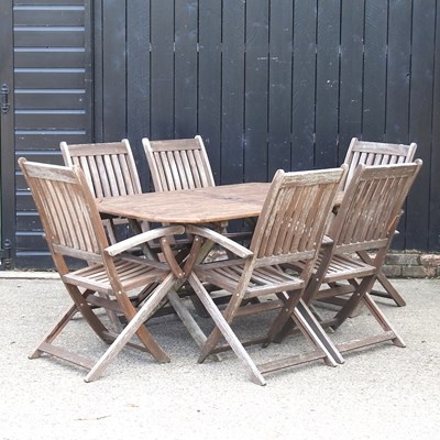 Lot 3 - A teak garden table, 149cm wide, together with...