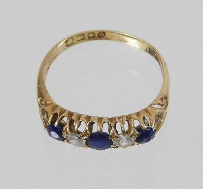 Lot 41 - An 18 carat gold five stone sapphire and diamond ring
