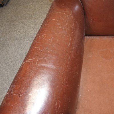 Lot 79 - A 1920's brown upholstered sofa