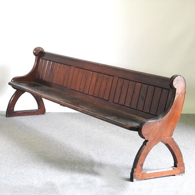 Lot 339 - A 19th century stained pine church pew, with a...