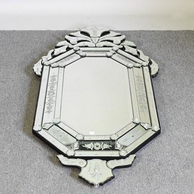Lot 398 - A Venetian style cushion wall mirror, the...