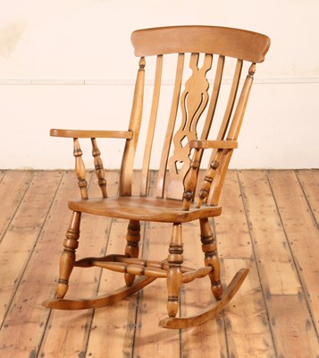 Lot 48 - A beech farmhouse rocking chair, 20th century,...