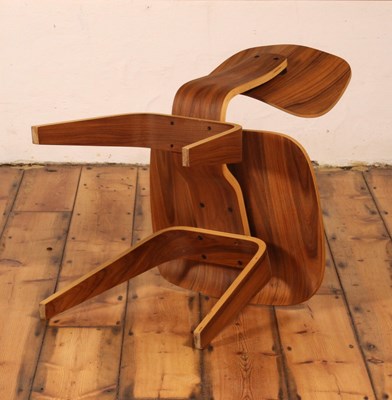 Lot 17 - An LCW walnut and plywood chair, after a...