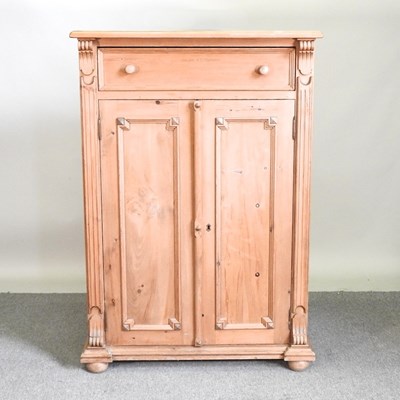 Lot 21 - A pine side cabinet, with a single drawer and...