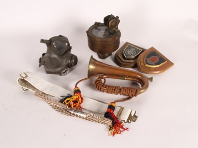 Lot 91 - A collection of militaria, to include a brass...