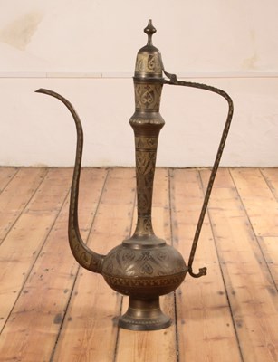 Lot 95 - An unusually large Indian brass coffee pot,...