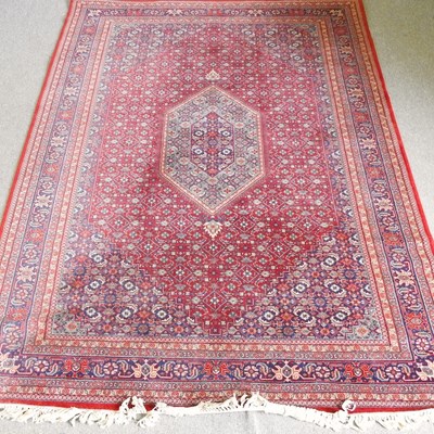 Lot 476 - A Persian rug, with a central medallion and...