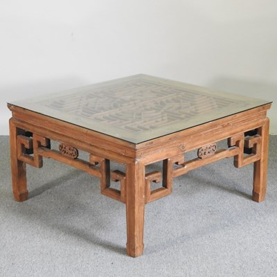 Lot 389 - A Chinese elm coffee table, with a glass top