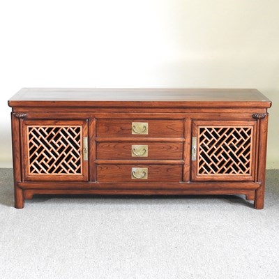 Lot 183 - A Chinese low two door cabinet. with drawers