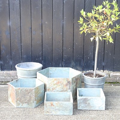 Lot 447 - A collection of stone garden pots, together...
