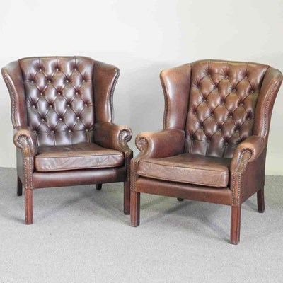 Lot 444 - A pair of brown leather upholstered wing...