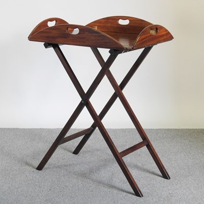 Lot 409 - A hardwood butler's tray on a folding stand (2)